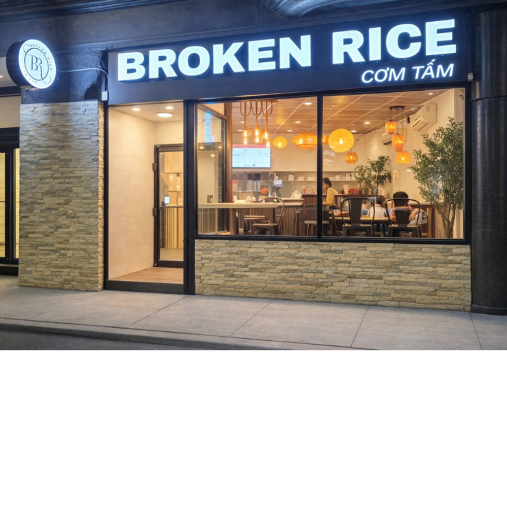 Broken Rice storefront with illuminated sign and a warmly lit dining room